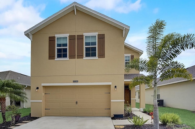 view of front of house with central AC unit and a garage