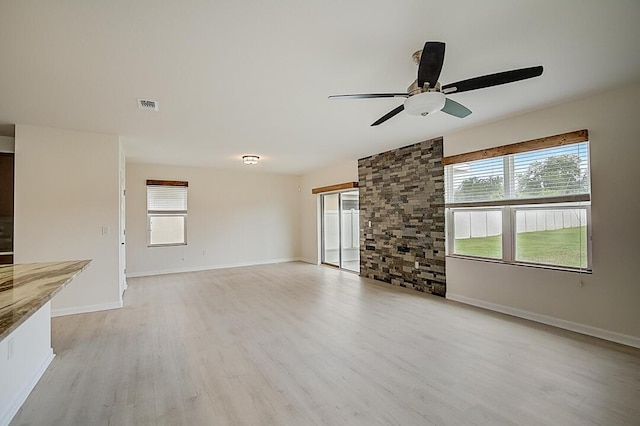 unfurnished living room featuring ceiling fan and light hardwood / wood-style flooring