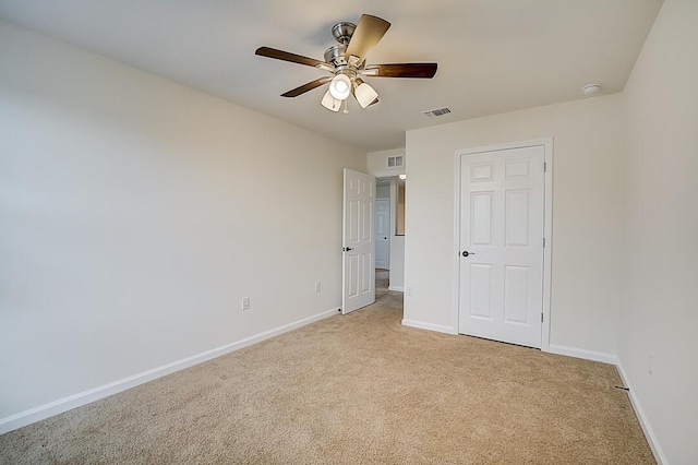 unfurnished bedroom featuring light carpet and ceiling fan