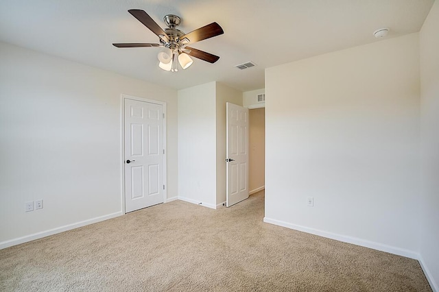 interior space featuring light colored carpet and ceiling fan