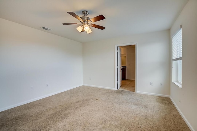 unfurnished room featuring light colored carpet and ceiling fan