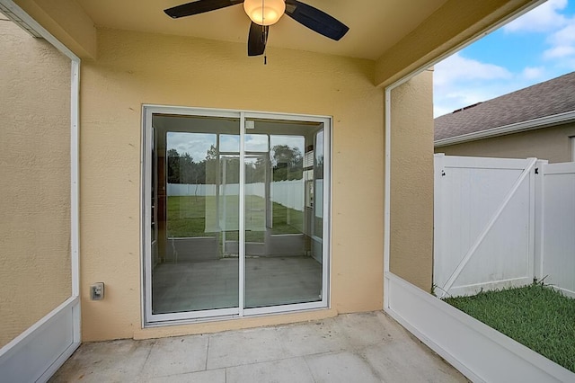 property entrance featuring a patio area and ceiling fan