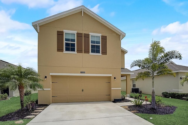 view of front of property with a front yard, central AC, and a garage