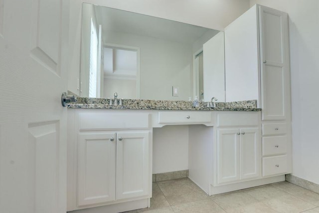 bathroom with vanity and tile flooring