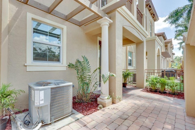 doorway to property featuring a patio and central air condition unit