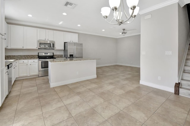 kitchen featuring white cabinets, light tile floors, a notable chandelier, and appliances with stainless steel finishes