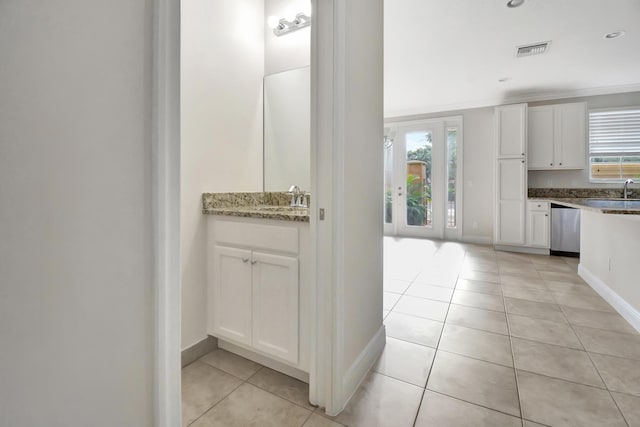 interior space with tile flooring and oversized vanity