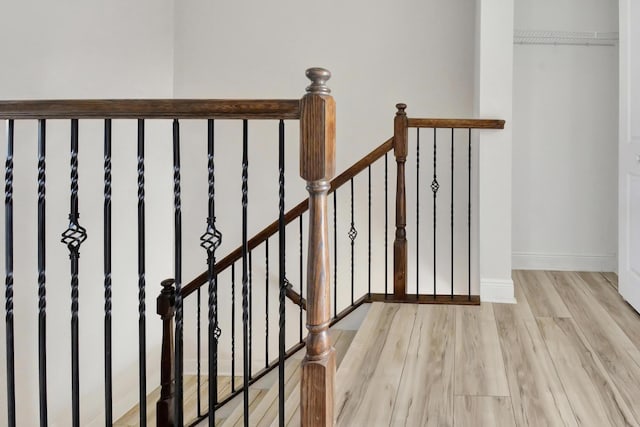 stairway with light wood-type flooring