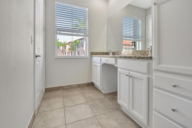 bathroom with vanity and tile flooring