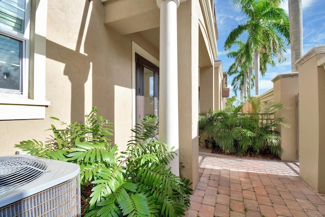 entrance to property with central air condition unit and a patio area