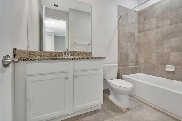 full bathroom featuring tiled shower / bath, toilet, tile flooring, and vanity