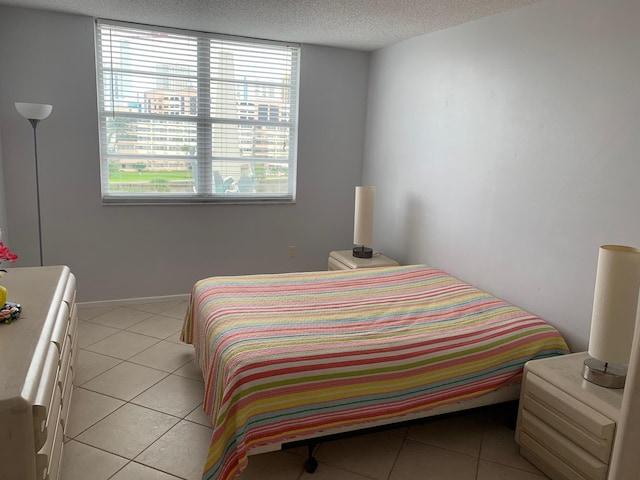 tiled bedroom with a textured ceiling