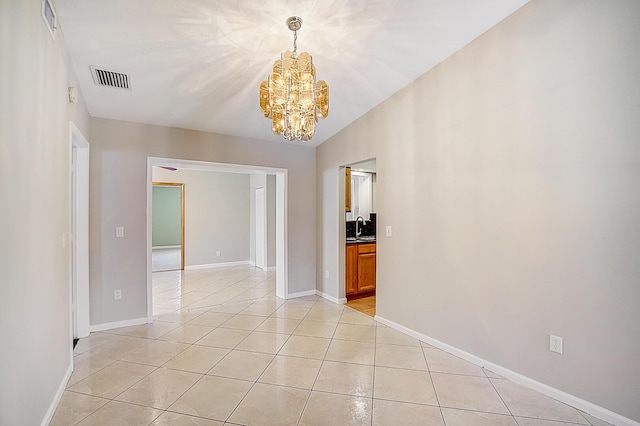 tiled spare room with a notable chandelier, vaulted ceiling, and sink