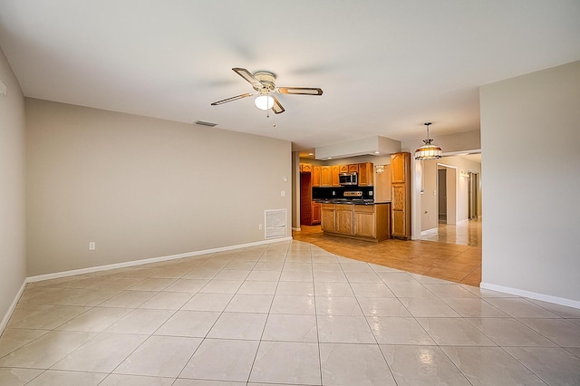 unfurnished living room with light tile floors and ceiling fan