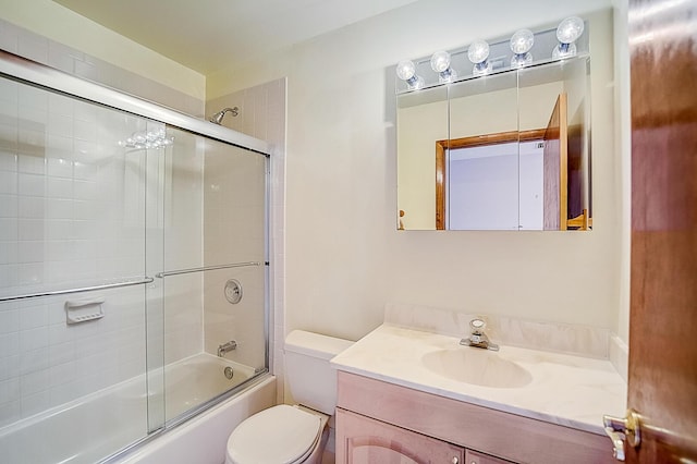 full bathroom with toilet, vanity, and shower / bath combination with glass door