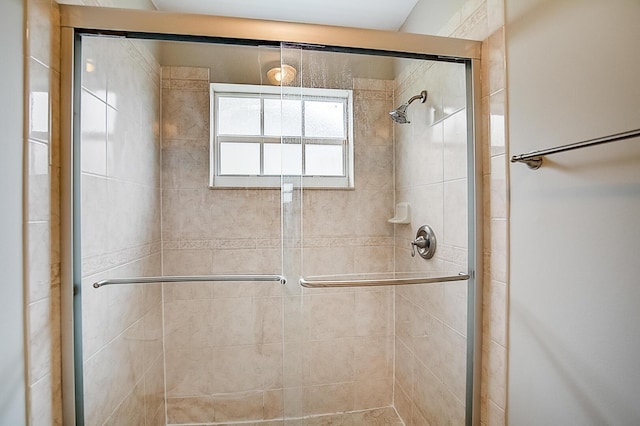 bathroom with a shower with shower door