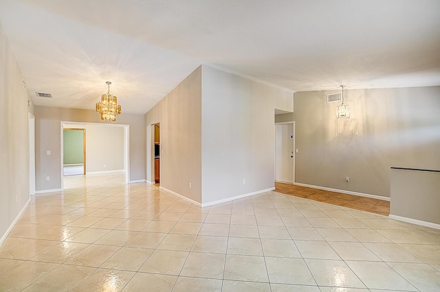 spare room with light tile floors and a notable chandelier