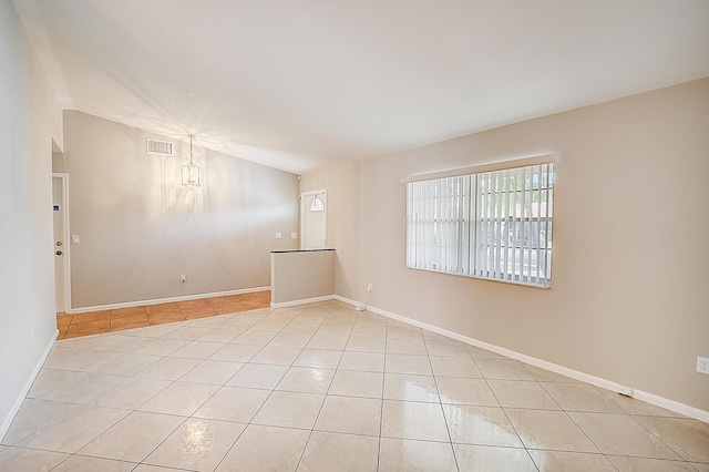 spare room with light tile floors