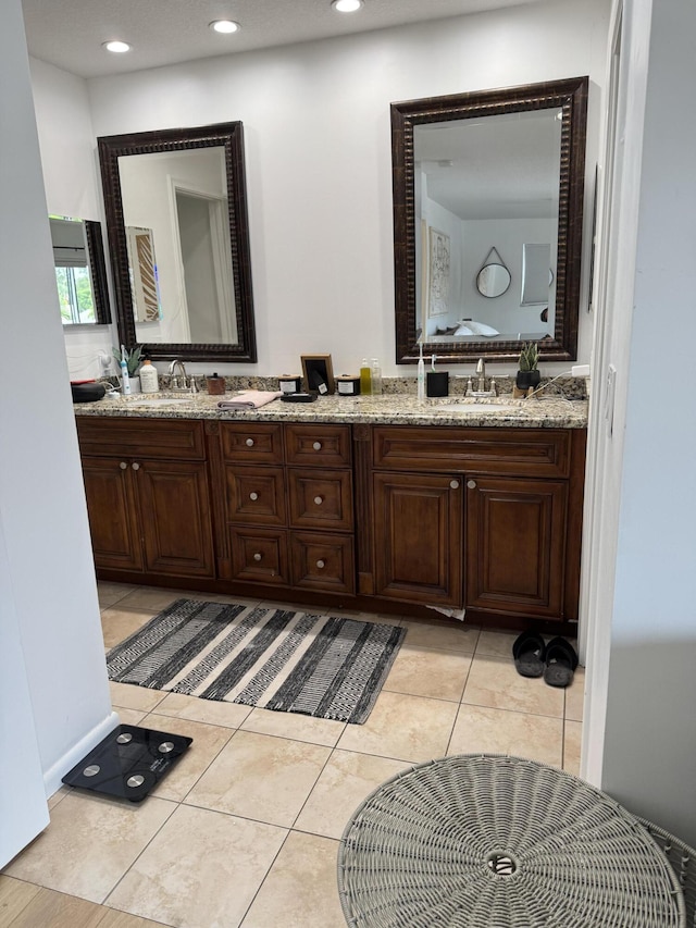 bathroom with double vanity, recessed lighting, and tile patterned flooring
