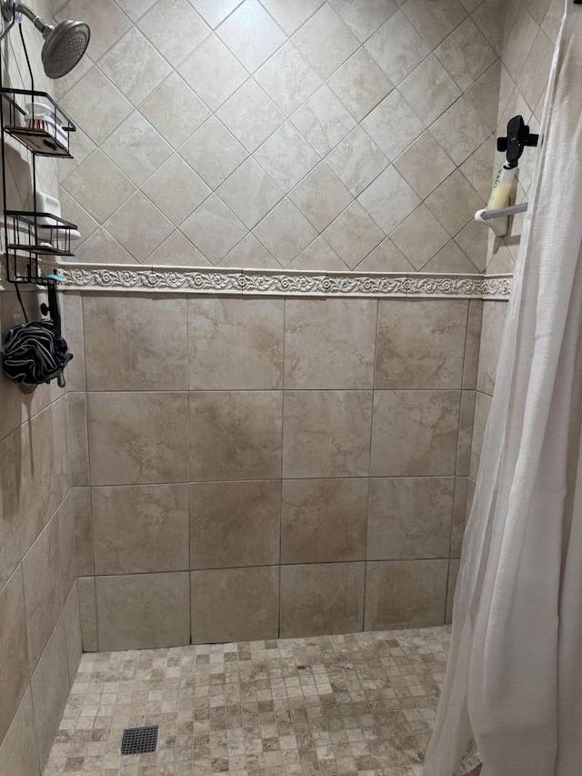bathroom with tiled shower