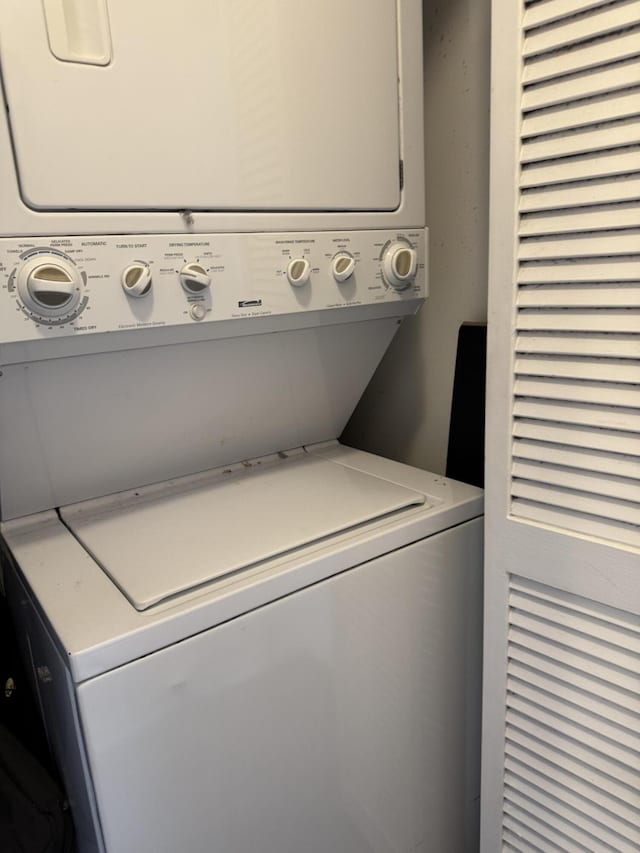 clothes washing area featuring stacked washer / drying machine