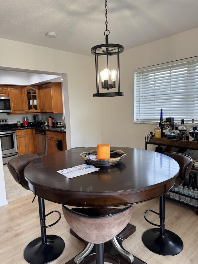dining area featuring light wood-style flooring and a chandelier