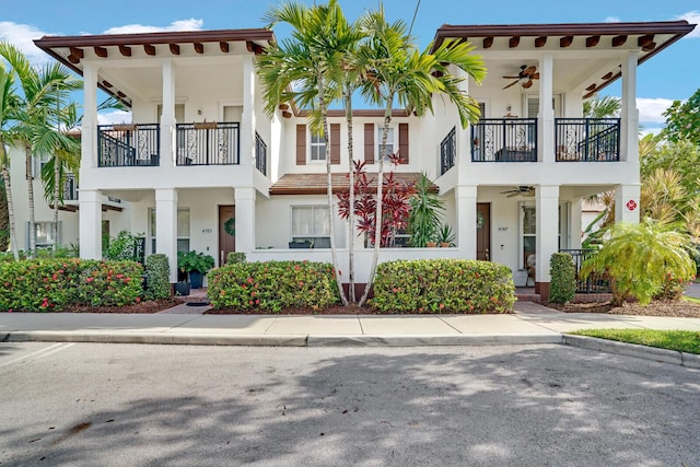 mediterranean / spanish-style house with a balcony and ceiling fan