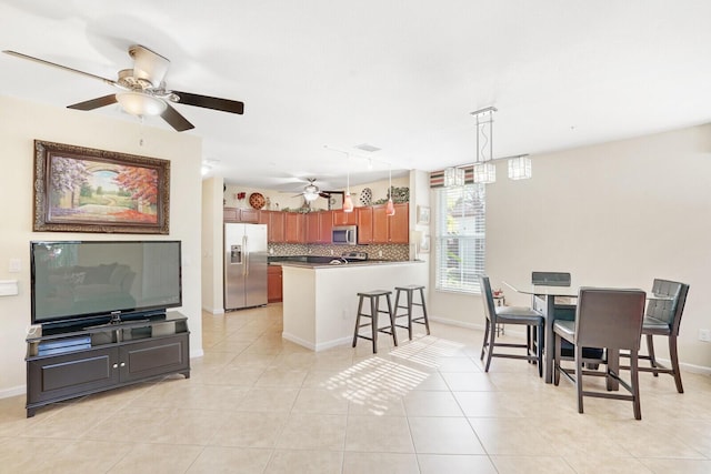 dining space with light tile floors and ceiling fan