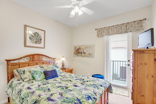 carpeted bedroom featuring access to outside, multiple windows, and ceiling fan