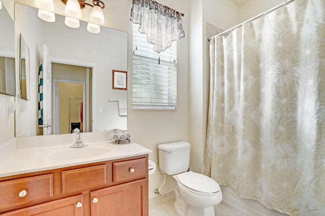 bathroom with tile floors, toilet, and vanity