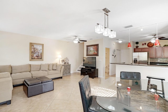 tiled dining space with ceiling fan