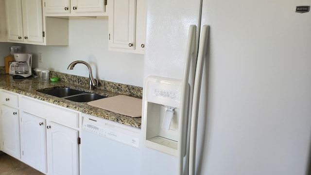 kitchen featuring white appliances, white cabinets, sink, and dark stone countertops