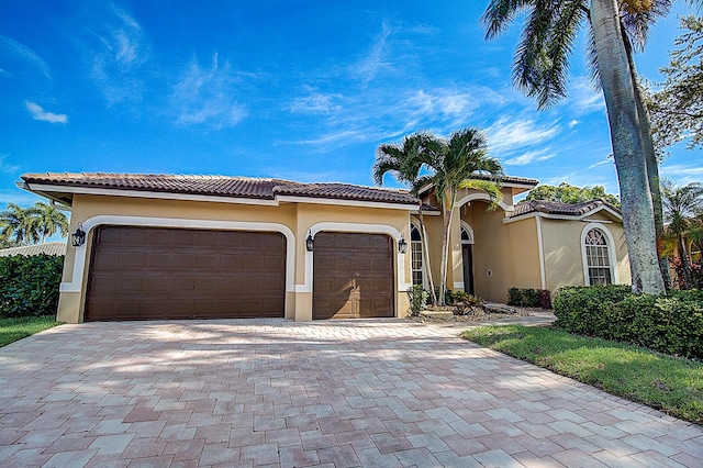 mediterranean / spanish home featuring a garage