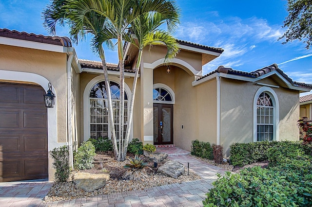 doorway to property with a garage