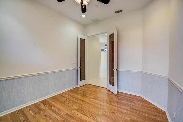 spare room with ceiling fan and light tile floors