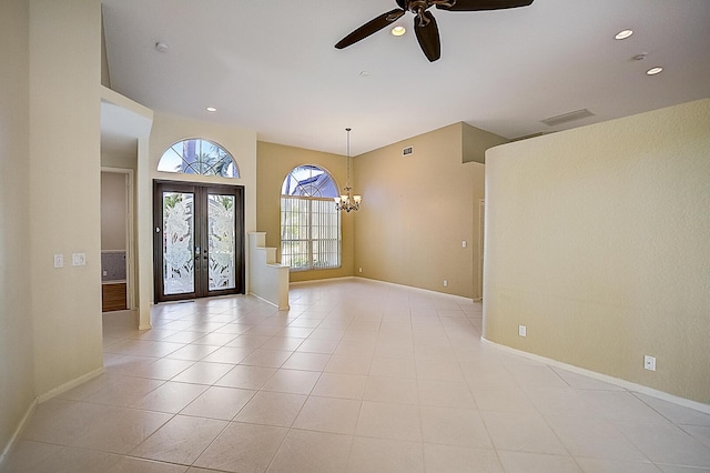 foyer entrance with french doors, light tile flooring, and ceiling fan with notable chandelier