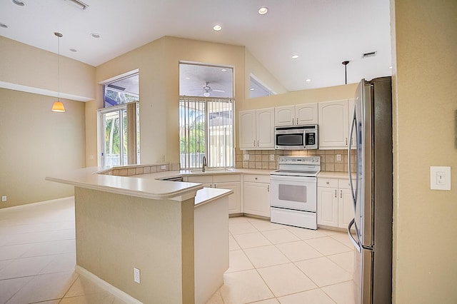 kitchen with kitchen peninsula, light tile floors, stainless steel appliances, decorative light fixtures, and white cabinetry