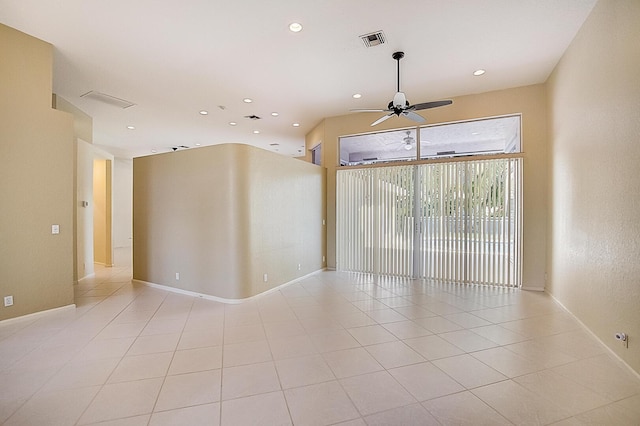 tiled spare room with ceiling fan