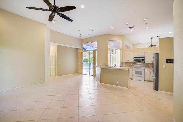 kitchen with tasteful backsplash, light tile flooring, ceiling fan, and appliances with stainless steel finishes