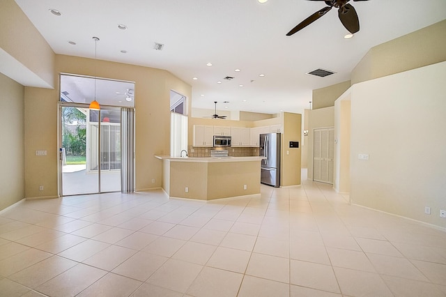 kitchen with appliances with stainless steel finishes, backsplash, ceiling fan, and pendant lighting