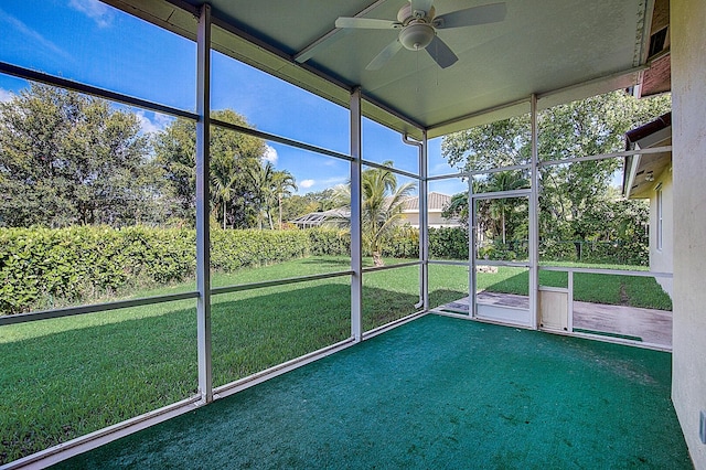 unfurnished sunroom featuring a healthy amount of sunlight and ceiling fan