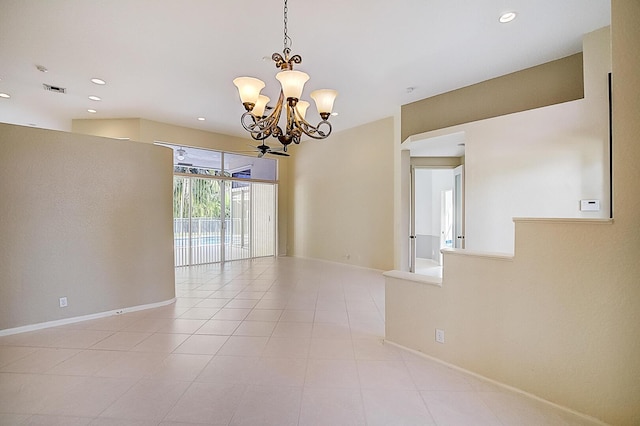 tiled empty room featuring a chandelier