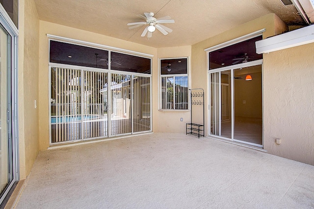 interior space with ceiling fan