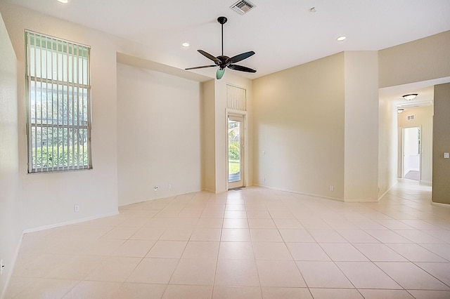 spare room featuring ceiling fan and light tile floors