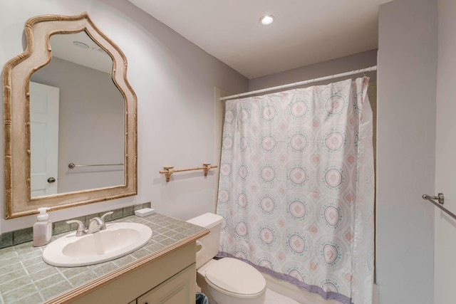 bathroom featuring large vanity and toilet