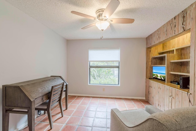 office with light tile floors, a textured ceiling, and ceiling fan