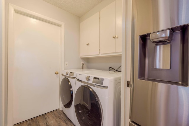 laundry room with cabinets, wood-type flooring, electric dryer hookup, a textured ceiling, and independent washer and dryer