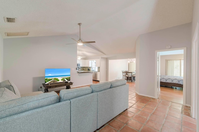 tiled living room with a healthy amount of sunlight, vaulted ceiling, and ceiling fan