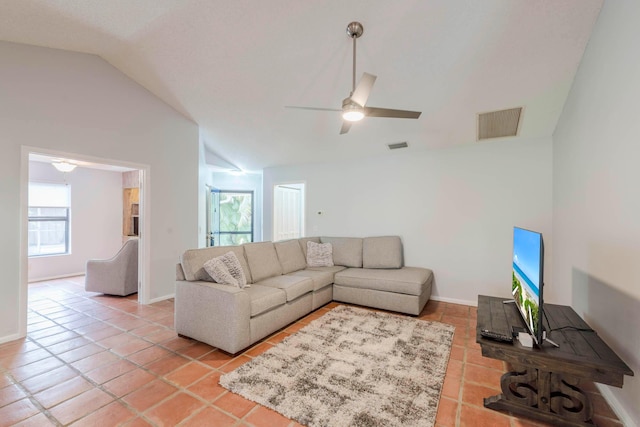 living room featuring vaulted ceiling, ceiling fan, and light tile floors