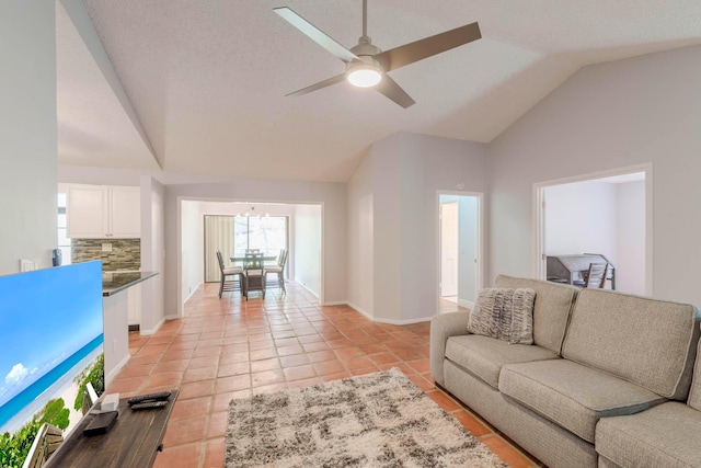 tiled living room with lofted ceiling and ceiling fan